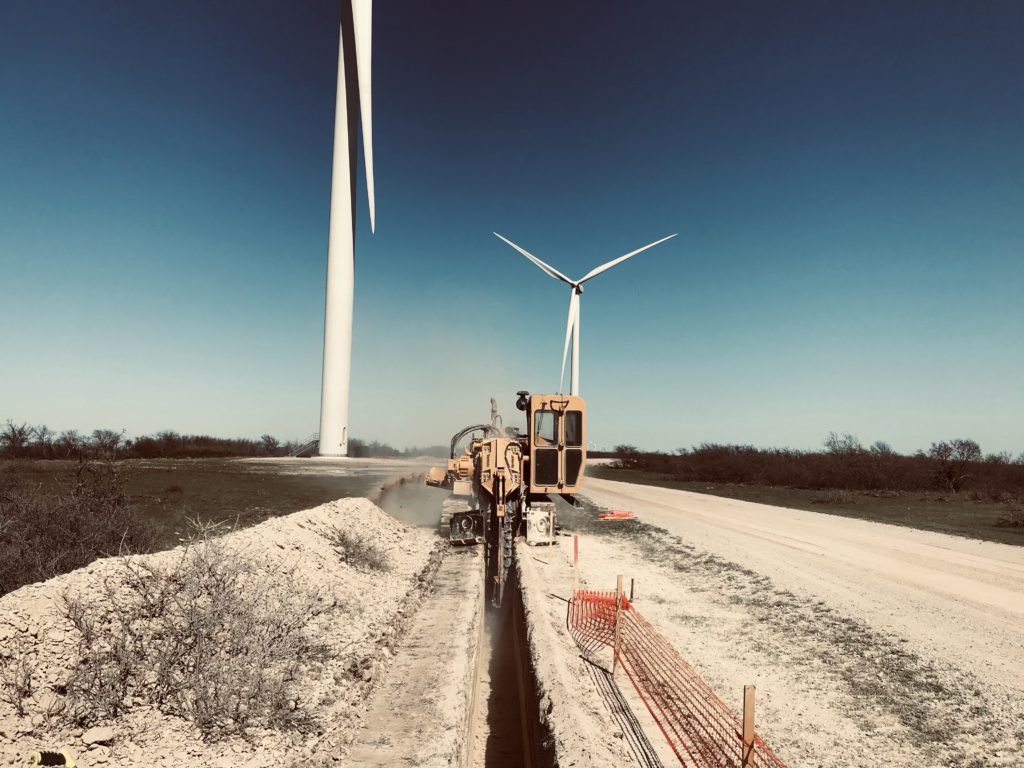 Machinery drilling a trench for construction